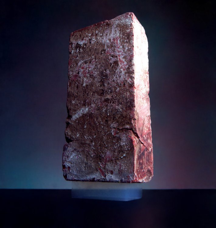 A 2.5 kg brick is supported by a piece of aerogel with a mass of 2 g