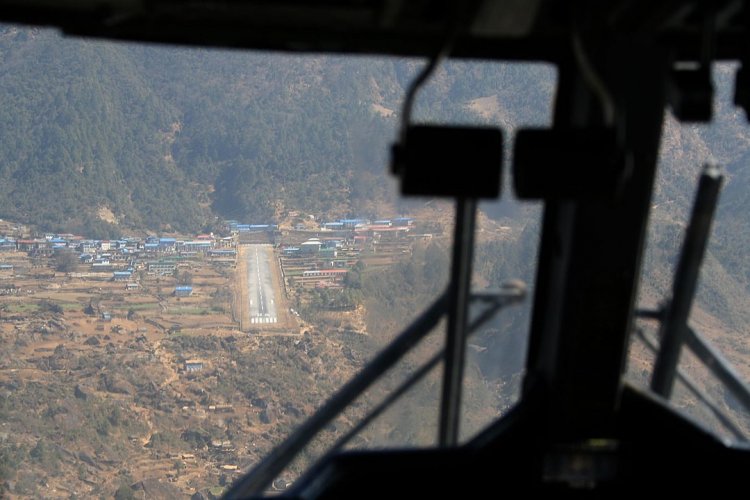 View of the shortest runway in the world at Tenzing–Hillary Airport from the cockpit. A plane with a shortened takeoff of the Twin Otter brand comes in for a landing. 